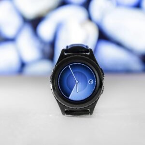 A sleek digital smartwatch with a blue interface against an abstract blurred background. Stylish and modern.